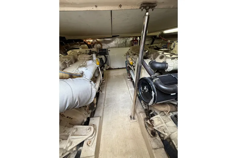 Slide: The Image of Engine room of 2005 Riviera 40 Flybridge yacht, showcasing dual engines and mechanical components. - 28
