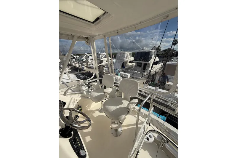 Slide: The Image of Flybridge view of 2005 Riviera 40 yacht, showcasing helm and marina backdrop. - 32