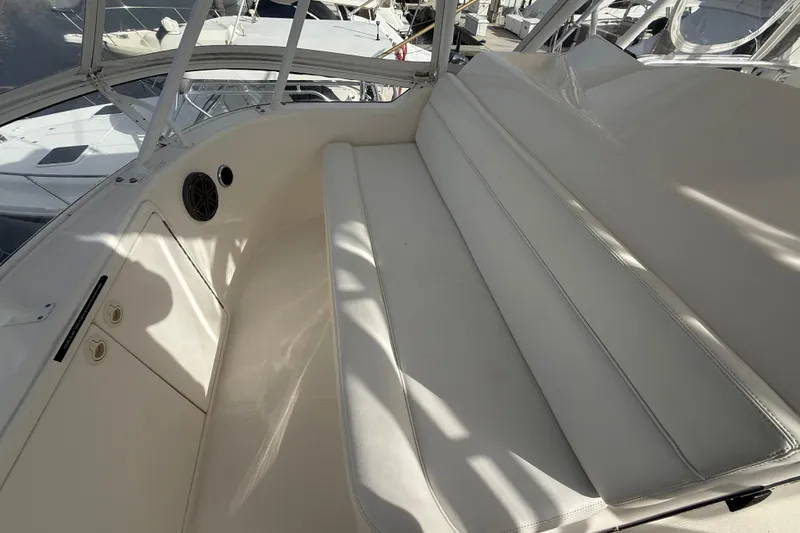 Slide: The Image of 2005 Riviera 40 Flybridge interior with white seating and speaker detail. - 35