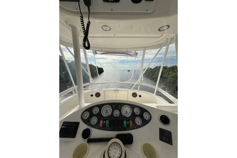Slide: The Image of 2005 Riviera 40 Flybridge helm view with ocean and sky in background. - 38
