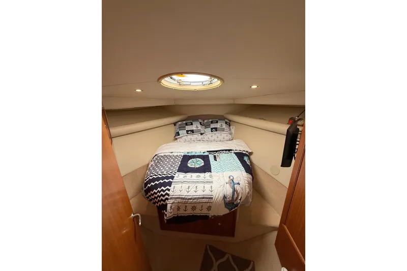 Slide: The Image of Cozy bedroom in 2005 Riviera 40 Flybridge yacht with nautical-themed bedding. - 9