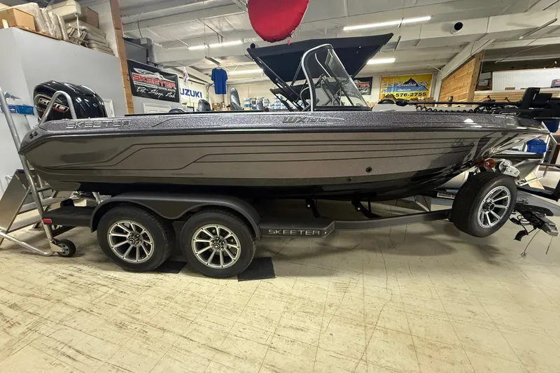 The Image of 2026 Skeeter WX1910 boat on trailer in showroom, side view. - 0