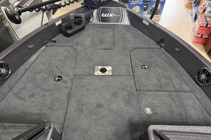 Slide: The Image of 2026 Skeeter WX1910 boat interior with carpeted deck and storage compartments. - 11