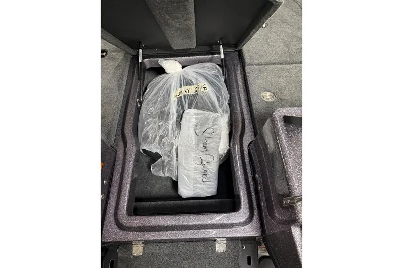 Slide: The Image of Storage compartment in 2026 Skeeter WX1910 boat, containing wrapped items. - 12