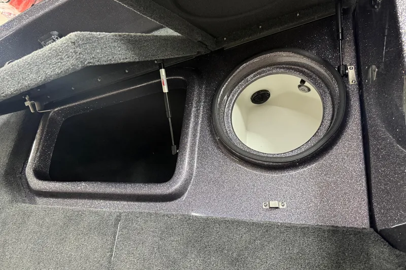 Slide: The Image of 2026 Skeeter WX1910 boat storage compartments with open hatch and circular access. - 14