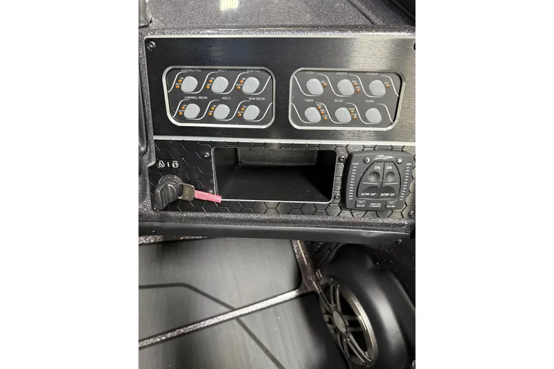 Slide: The Image of Control panel of 2026 Skeeter WX1910 boat with switches and speaker. - 15