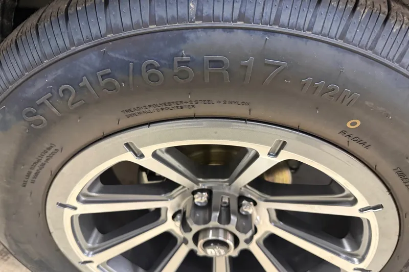 Slide: The Image of Close-up of a tire on a 2026 Skeeter WX1910, showing size and specifications. - 19