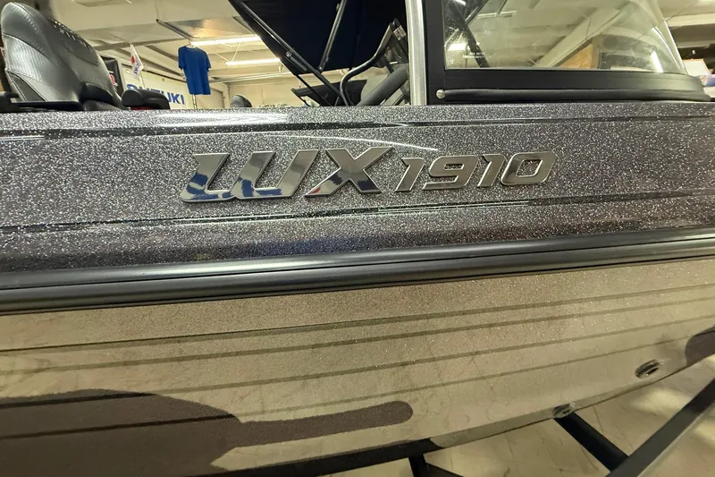 Slide: The Image of 2026 Skeeter WX1910 boat with metallic finish, showcasing model name on the side. - 2