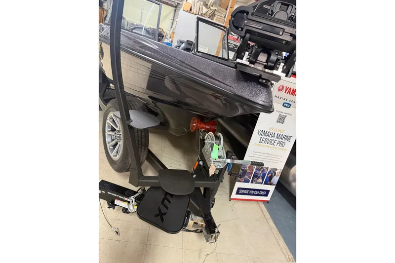 Slide: The Image of 2026 Skeeter WX1910 boat on trailer with Yamaha Marine Service Pro sign. - 22