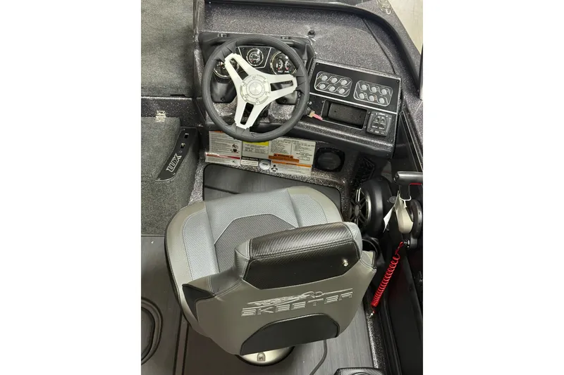 Slide: The Image of 2026 Skeeter WX1910 boat cockpit with steering wheel and control panel. - 8