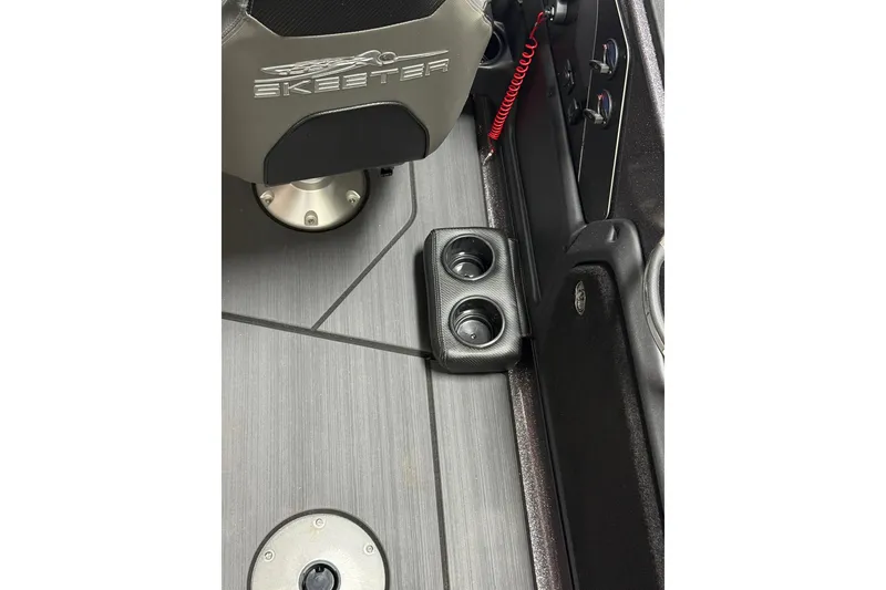 Slide: The Image of 2026 Skeeter WX1910 boat interior with cup holders and branded seat. - 9