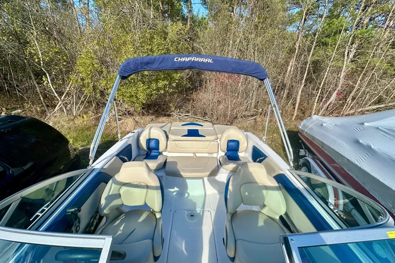 Slide: The Image of 2018 Chaparral 19 H2O Ski & Fish boat with canopy, parked outdoors. - 12