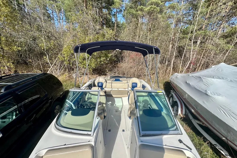 Slide: The Image of 2018 Chaparral 19 H2O Ski & Fish boat with canopy, parked outdoors. - 14