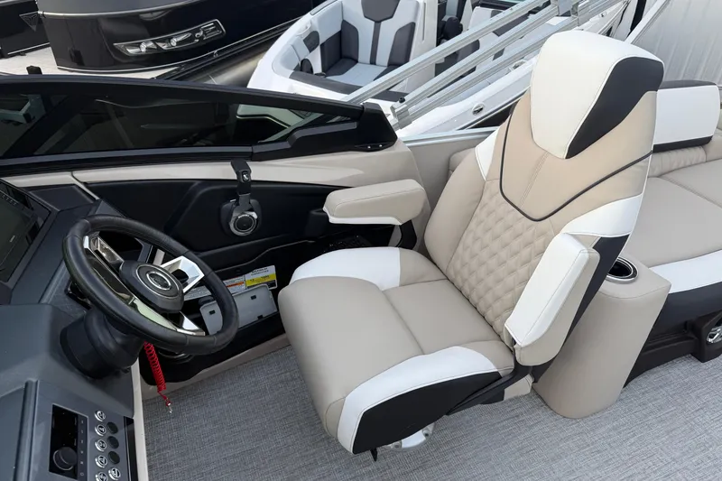 Slide: The Image of Luxurious 2026 Tahoe Pontoon Cascade Quad Lounger helm with plush seating and modern controls. - 4