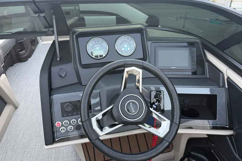 Slide: The Image of 2026 Tahoe Pontoon Cascade Quad Lounger dashboard with steering wheel and digital display. - 6