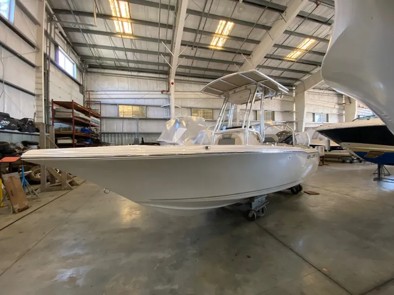 Slide: The Image of 2026 Key West 203 FS boat in a spacious indoor storage facility. - 2