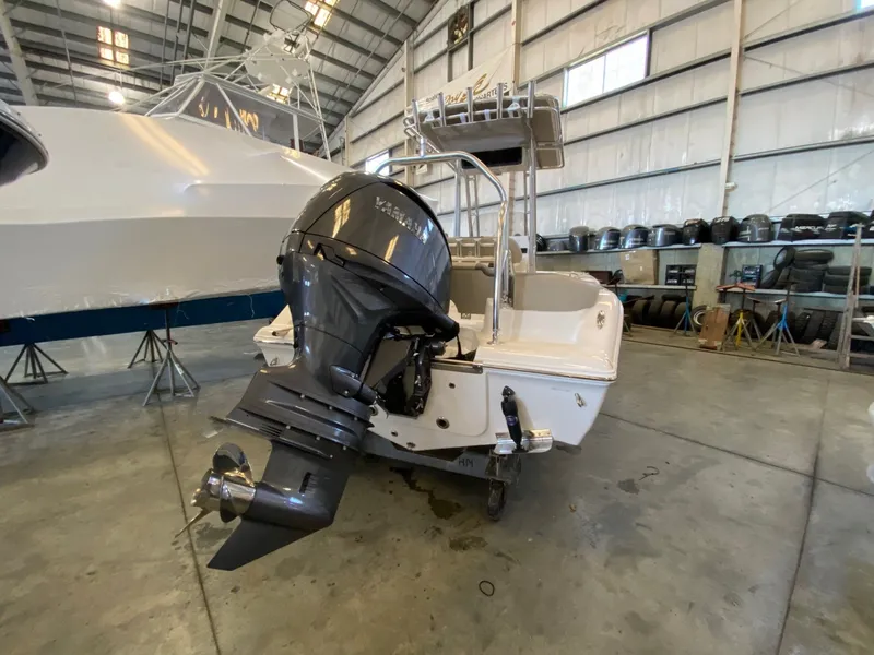 Slide: The Image of 2026 Key West 203 FS boat with Yamaha outboard motor in a storage facility. - 3