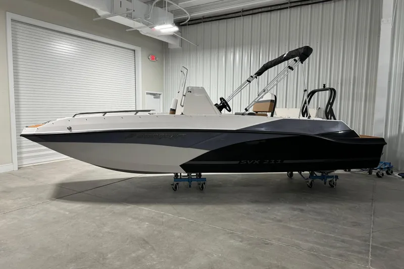 The Image of 2025 Starcraft SVX 211 OB CC boat in a showroom, side view. - 1