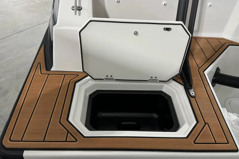 Slide: The Image of 2025 Starcraft SVX 211 OB CC boat storage compartment with wood-textured flooring. - 22