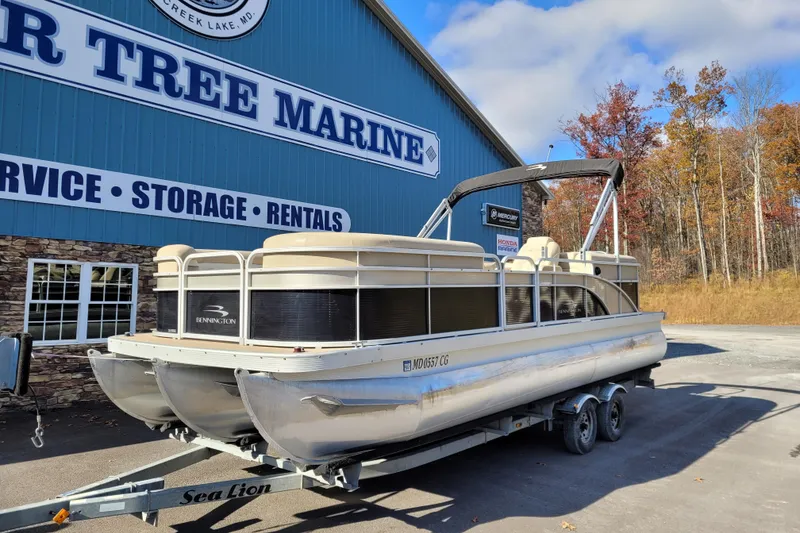 Slide: The Image of 2013 Bennington 24 SSRX pontoon boat on trailer at a marine service center. - 4
