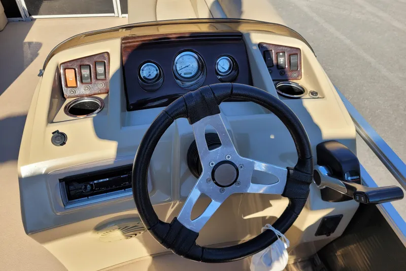 Slide: The Image of Steering console of a 2013 Bennington 24 SSRX pontoon boat with gauges and controls. - 8
