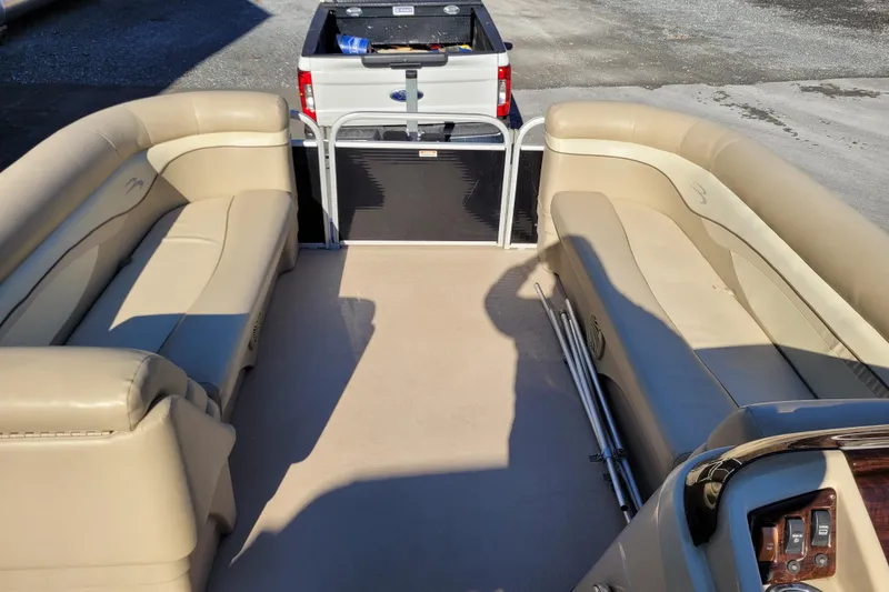Slide: The Image of 2013 Bennington 24 SSRX pontoon boat interior with beige seating and open deck. - 9