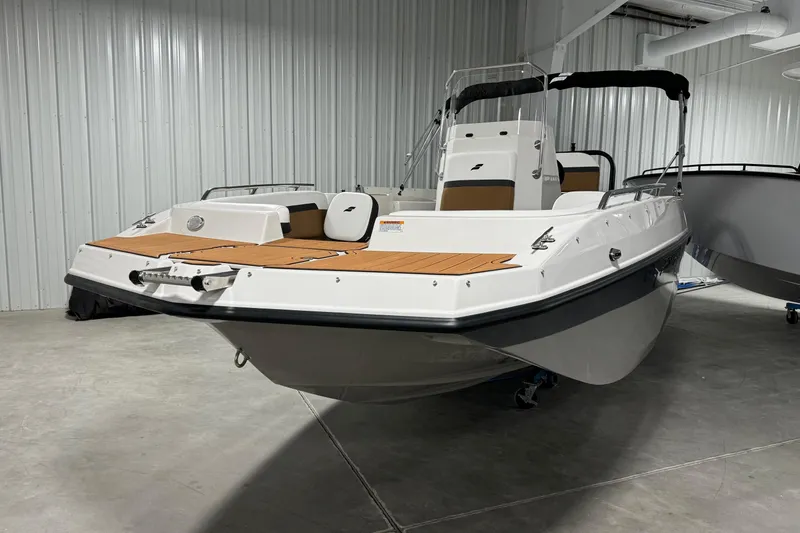 Slide: The Image of 2025 Starcraft SVX 211 OB CC boat in showroom, featuring sleek design and modern amenities. - 3