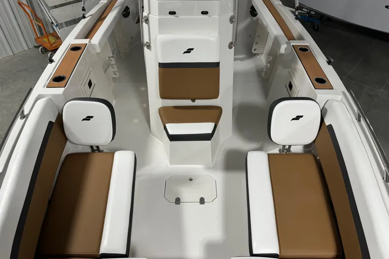 Slide: The Image of 2025 Starcraft SVX 211 OB CC boat interior with brown and white seating. - 6