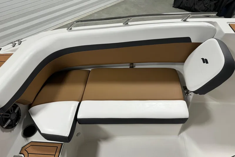 Slide: The Image of 2025 Starcraft SVX 211 OB CC boat interior with brown and white cushioned seating. - 8