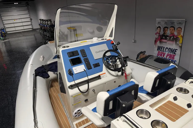 Slide: The Image of 2021 Sealegs 7.5M RIB with Garmin navigation system in a showroom setting. - 11