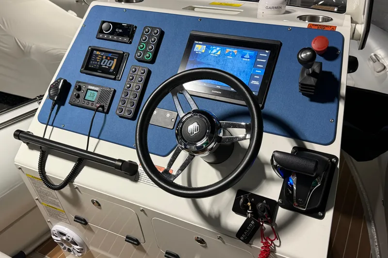 Slide: The Image of Sealegs 7.5M RIB 2021 dashboard with steering wheel, controls, and navigation display. - 13