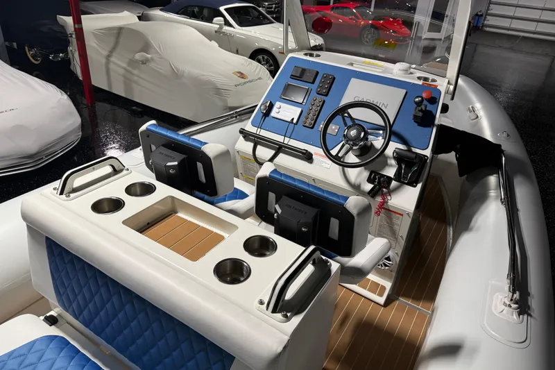 Slide: The Image of 2021 Sealegs 7.5M RIB boat interior with steering console and blue seating. - 18