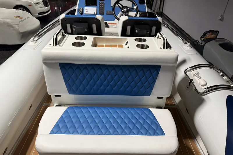 Slide: The Image of 2021 Sealegs 7.5M RIB interior with blue quilted seats and modern dashboard. - 19
