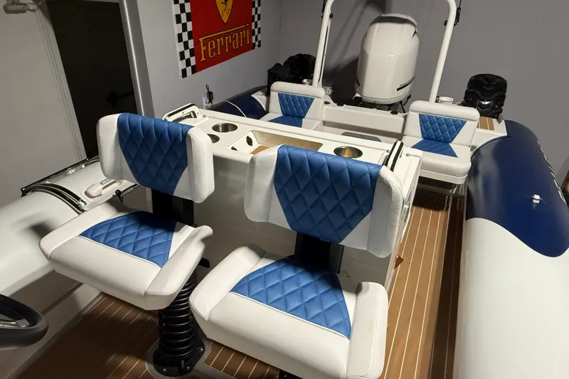 Slide: The Image of 2021 Sealegs 7.5M RIB with blue and white seating, Ferrari poster in background. - 22