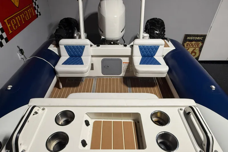Slide: The Image of 2021 Sealegs 7.5M RIB interior with blue seating and wood flooring. - 24