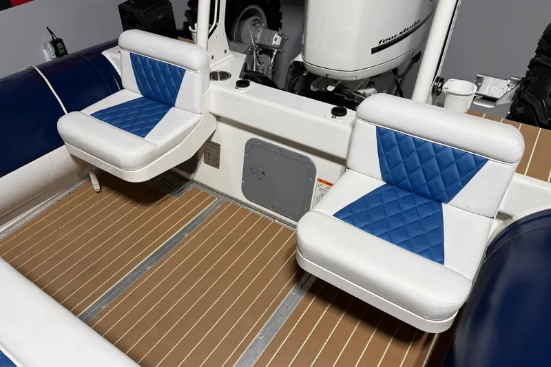 Slide: The Image of 2021 Sealegs 7.5M RIB interior with blue and white cushioned seats. - 26