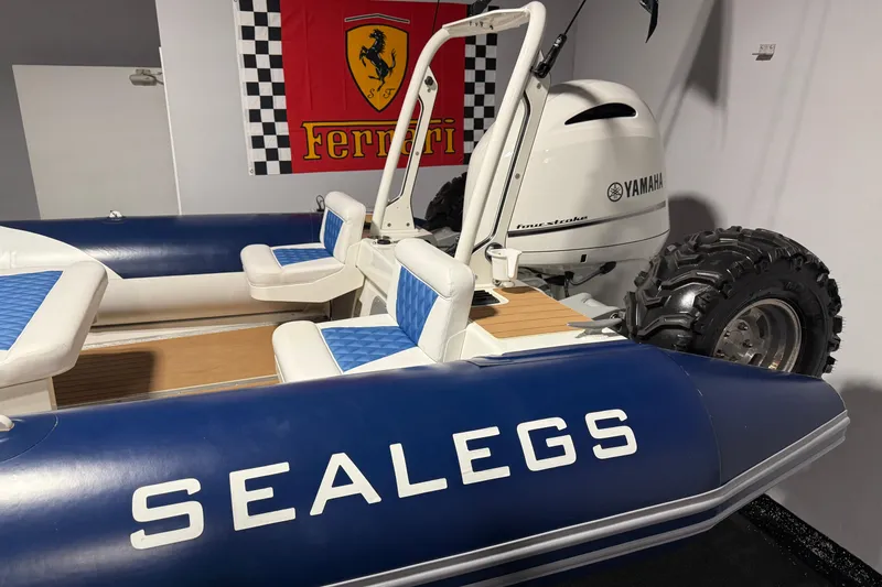 Slide: The Image of Sealegs 7.5M RIB 2021 with Yamaha engine, displayed indoors near Ferrari banner. - 29