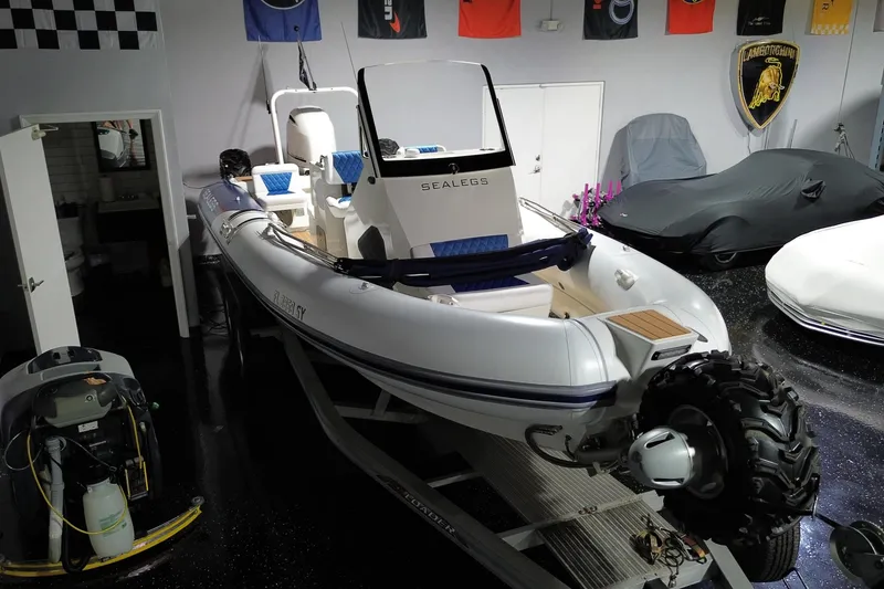 Slide: The Image of 2021 Sealegs 7.5M RIB in showroom, featuring amphibious wheels and sleek design. - 3