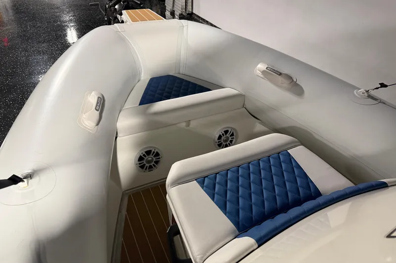 Slide: The Image of 2021 Sealegs 7.5M RIB with blue and white seating, showcasing interior design. - 7