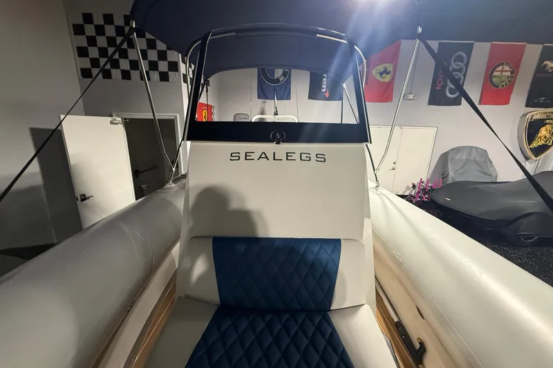Slide: The Image of 2021 Sealegs 7.5M RIB boat interior with blue seating and canopy. - 9
