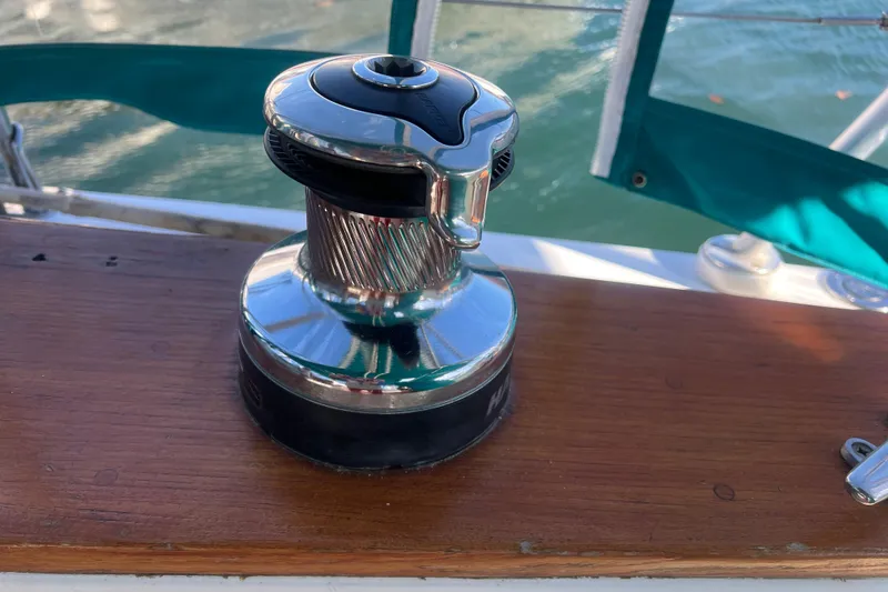 Slide: The Image of Chrome winch on 1993 Compac Sloop sailboat deck, with green canvas backdrop. - 11