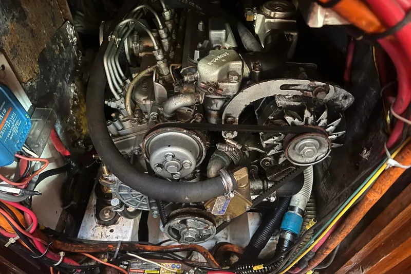 Slide: The Image of Engine compartment of a 1993 Compac Sloop sailboat, showing detailed mechanical components. - 13