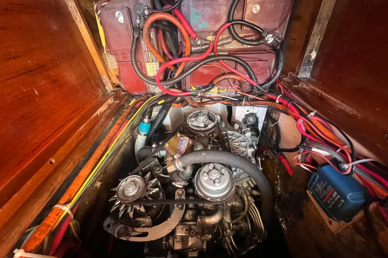Slide: The Image of Engine compartment of a 1993 Compac Sloop with visible wiring and components. - 14