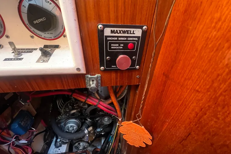 Slide: The Image of 1993 Compac Sloop interior showing Maxwell anchor winch control and engine components. - 15