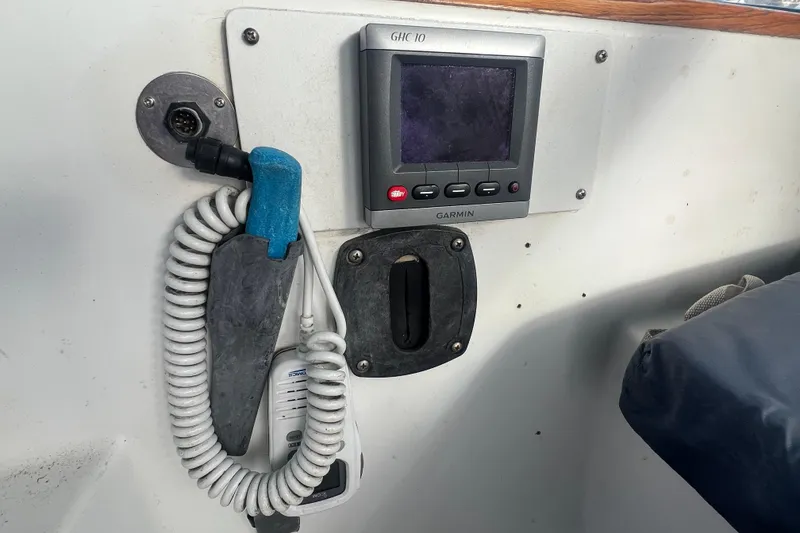 Slide: The Image of Control panel of a 1993 Compac Sloop with Garmin GHC 10 display and coiled cable. - 20