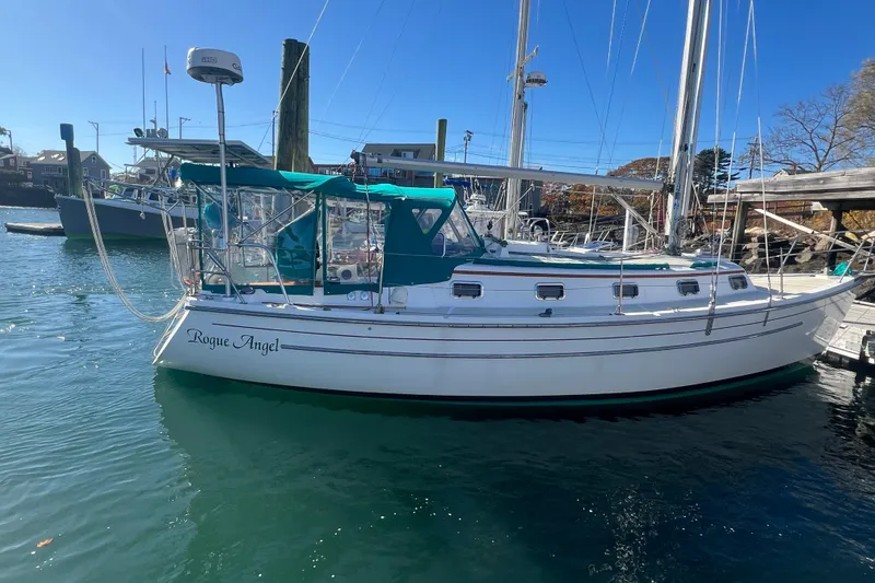 Slide: The Image of 1993 Compac Sloop sailboat "Rogue Angel" docked in a sunny marina. - 3
