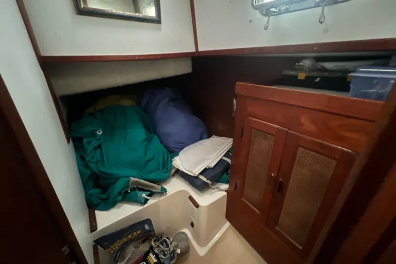 Slide: The Image of Interior cabin of 1993 Com-Pac Sloop with storage and wooden cabinetry. - 32