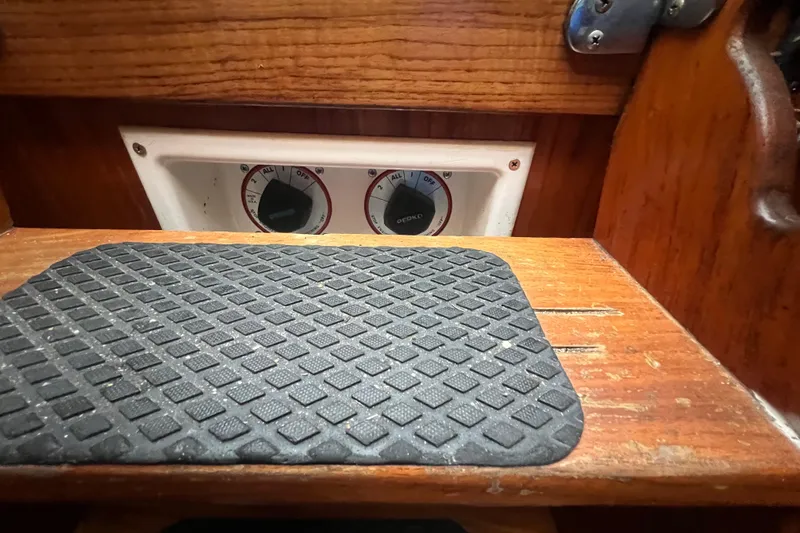 Slide: The Image of 1993 Com-Pac Sloop interior with control panel and non-slip mat. - 36