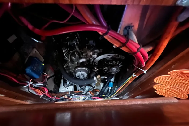 Slide: The Image of Engine compartment of a 1993 Com-Pac Sloop with visible wiring and components. - 37