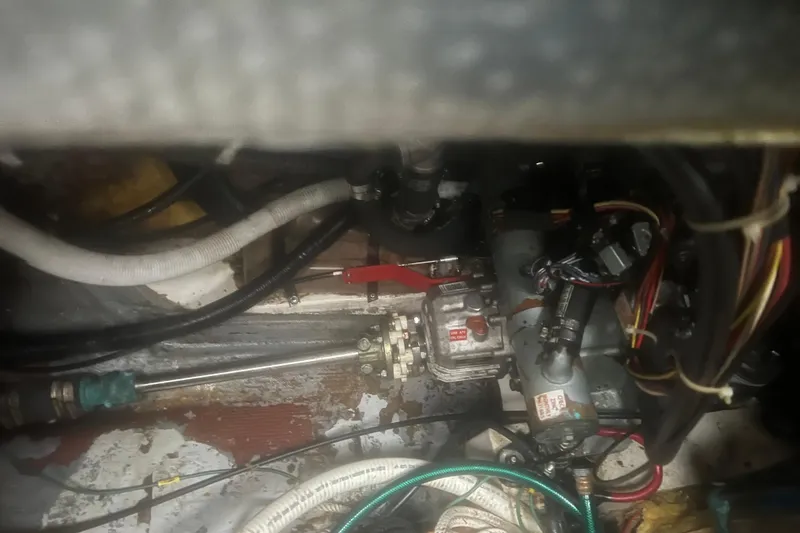 Slide: The Image of Engine compartment of a 1993 Com-Pac Sloop, showing mechanical components and wiring. - 39